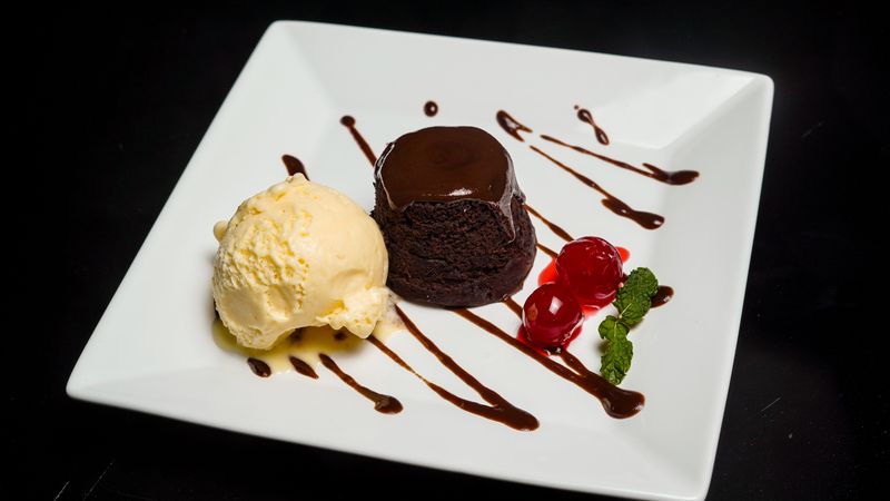 Dark chocolate fondant with vanilla ice cream and caramel sauce